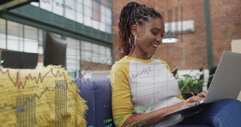 Smiling Woman Analyzing Financial Chart on Laptop in Modern Loft
