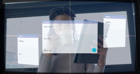 Backlit professional tapping tablet while sipping coffee with transparent sync ui overlay