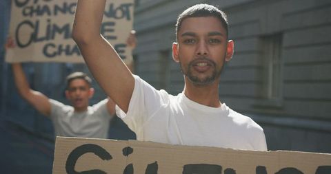 Young protestors marching for equal rights with placard