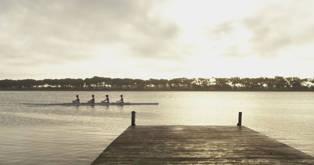 Four Athletes Rowing in Synchrony on Tranquil River at Sunrise - Download Free Stock Images Pikwizard.com