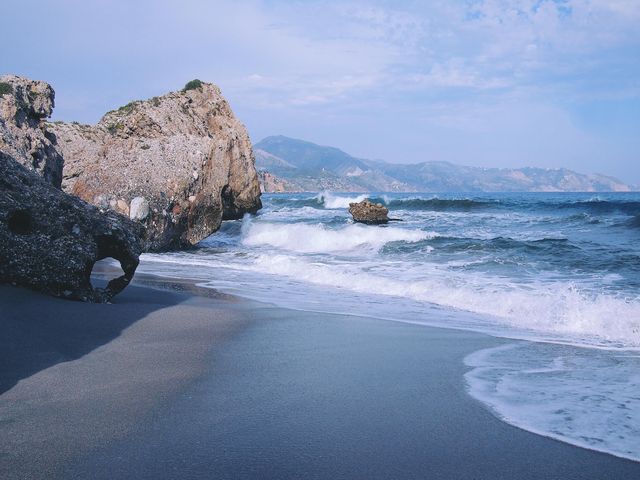 Serene Rocky Beach with Gentle Waves in Daylight - Download Free Stock Photos Pikwizard.com