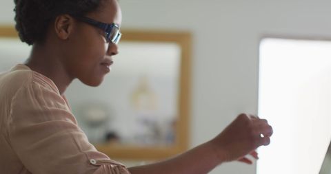 Relaxed african american woman using laptop at home