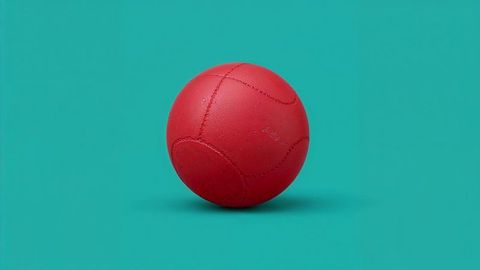 Minimalist dodge ball on vibrant teal surface