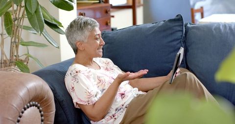 Senior Biracial Woman Using Tablet at Home Relaxing on Couch - Download Free Stock Images Pikwizard.com