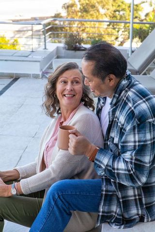 Diverse Couple Enjoying Coffee on Modern Terrace