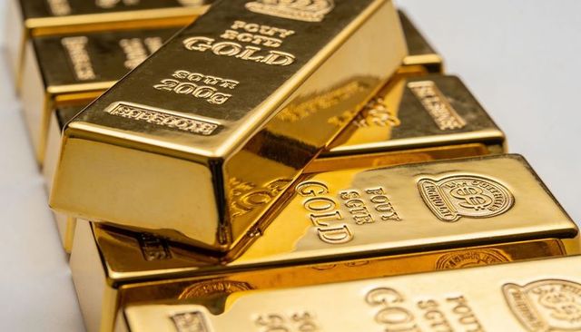 Stacked gold bars catching warm highlights reflective bullion ingots embossed hallmarks