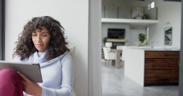 Middle-aged Woman Reading Tablet at Modern Home - Download Free Stock Images Pikwizard.com