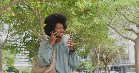 Smiling Woman with Coffee and Smartphone on City Street