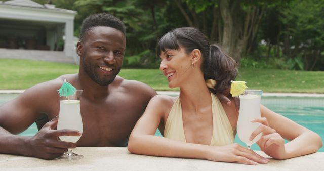 Happy Diverse Couple Enjoying Tropical Drinks by Swimming Pool - Download Free Stock Images Pikwizard.com