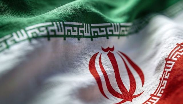 Macro close-up iranian flag central emblem and kufic border on waving textured textile