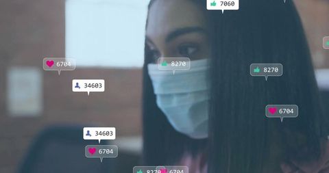 Office worker wearing surgical mask receiving social media engagement notifications
