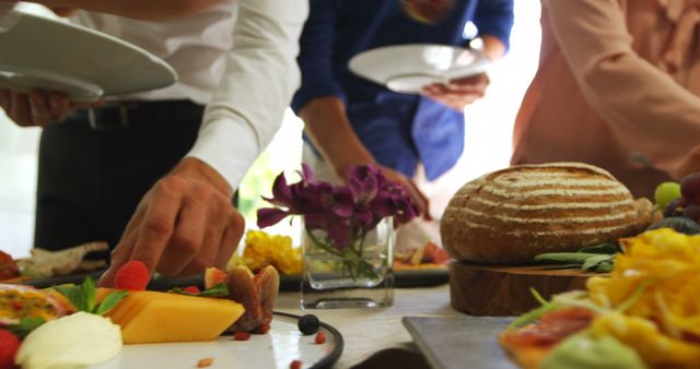 People Reaching for Food at a Buffet Table during Daytime Gathering - Download Free Stock Images Pikwizard.com