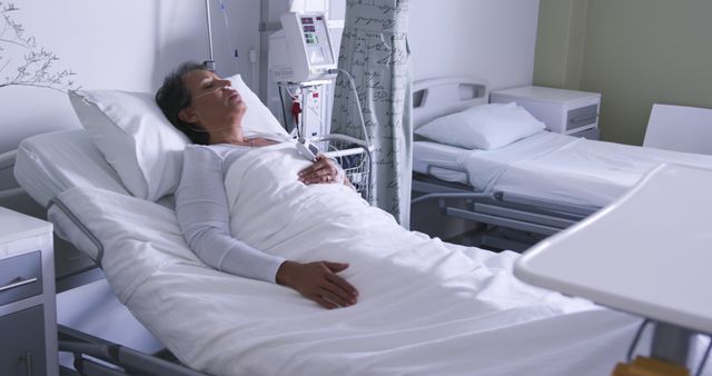 Elderly Woman Resting in Hospital Bed Under Medical Care - Download Free Stock Images Pikwizard.com