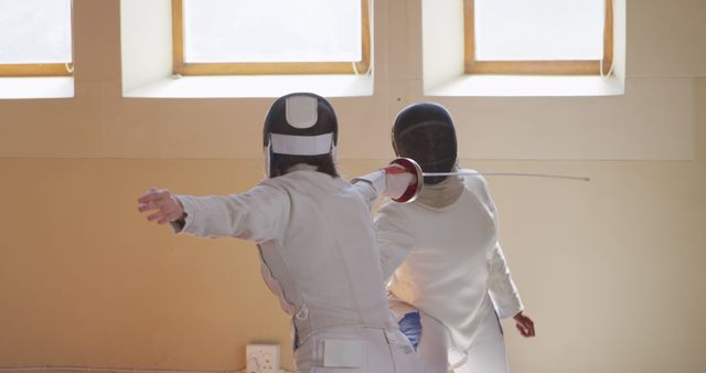 Two Women Engaging in Fencing Duel Indoors with Foil Swords - Download Free Stock Images Pikwizard.com