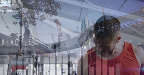 Man in Red Tank Bowing Head in Gym Overlaid with Construction Cranes and Financial Charts