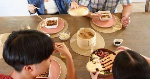 Family dining asian cuisine together at home