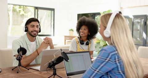 Creative Team Recording Podcast with Laptops and Microphones
