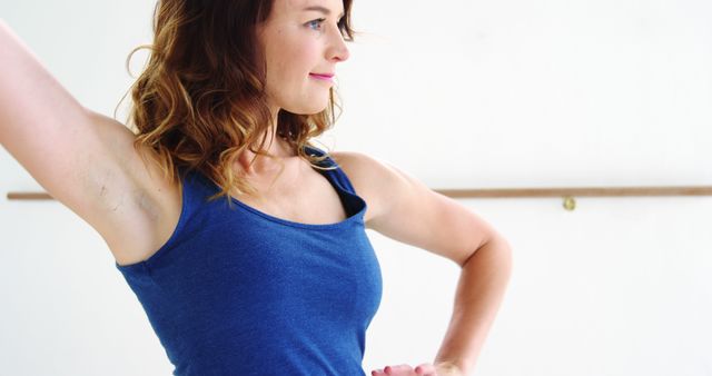 Smiling Woman in Blue Tank Top Posing with Arched Arm - Download Free Stock Images Pikwizard.com