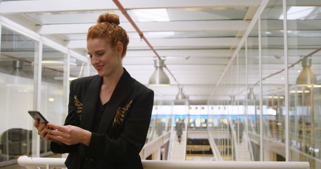 Smiling Businesswoman Texting on Smartphone in Modern Office Building - Download Free Stock Images Pikwizard.com