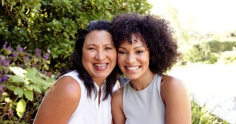 Smiling Mother and Daughter Bonding Outdoors Together