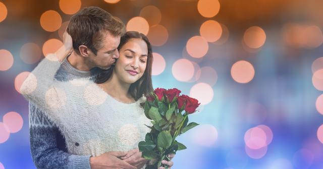 Romantic scene capturing a man kissing a woman holding red roses, surrounded by a soft, colorful bokeh background. Ideal for use in promotional materials for Valentine's Day, anniversaries, couple-related advertisements, and relationship blogs. Emphasizes themes of romance, love, and intimacy.
