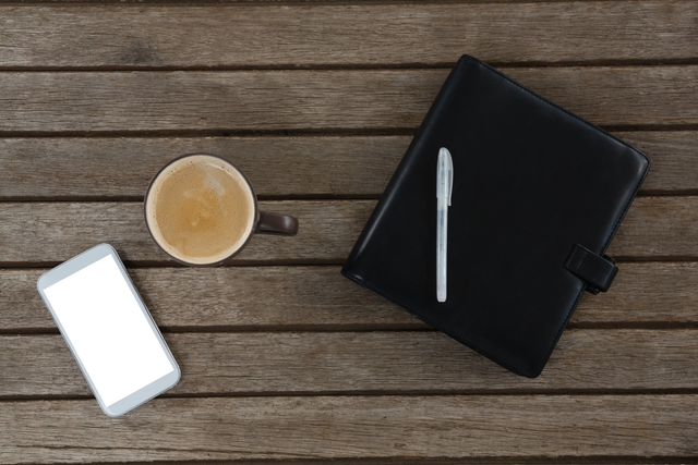 Transparent Overhead View of Coffee, Smartphone, Pen, and Planner on Wooden Table - Download Free Stock Videos Pikwizard.com