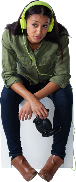 Biracial woman listening to music with green headphones, holding video game controller, transparent - Download Free Stock Videos Pikwizard.com