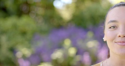 Relaxed Woman in Nature with Blurred Purple Flowers in Background