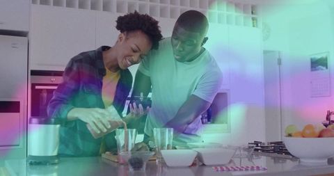 Couple Pouring Juice Together in Modern Kitchen