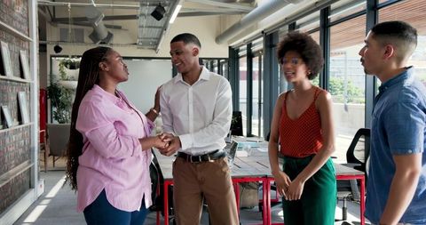 Diverse team celebrates success in office environment