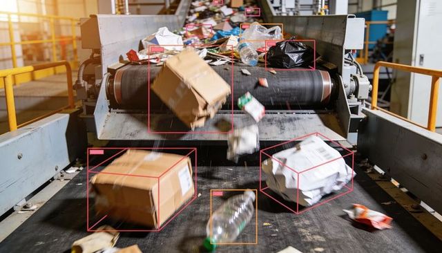 Recycling conveyor belt carrying mixed recyclables with automated object detection