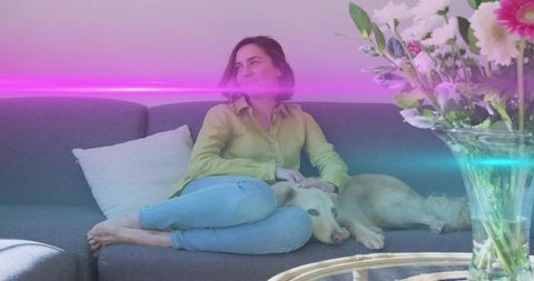 Woman relaxing with labrador retriever in cozy living room