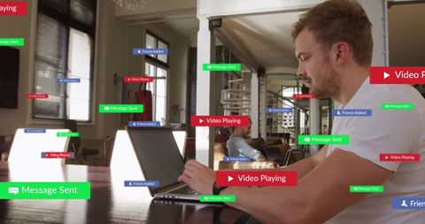 Man Working on Laptop with Digital Notifications in Modern Living Room