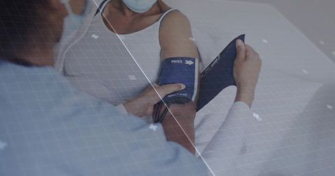 Doctor Measuring Blood Pressure of Patient in Medical Clinic