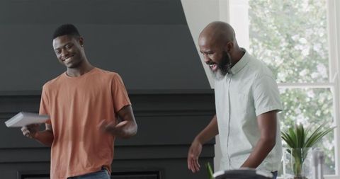 Friends reenacting speech with laughter and enthusiasm in living room