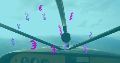 Currency Symbols Floating in Airplane Cockpit Over Mountain Peaks