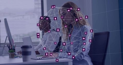 Coworkers collaborating at laptops with digital network overlay visualizing social connectivity