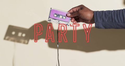 Retro vibes: hand holding vintage cassette tape