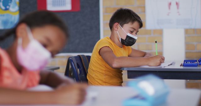 Elementary Students Wearing Masks and Studying in Classroom - Download Free Stock Images Pikwizard.com