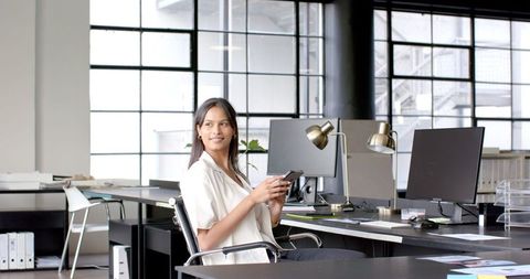 Executive Businesswoman Using Smartphone in Contemporary Office