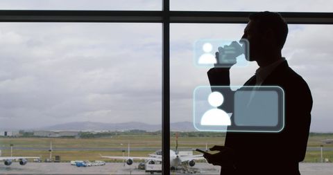 businessman reviewing social media at airport window - Download Free Stock Images Pikwizard.com