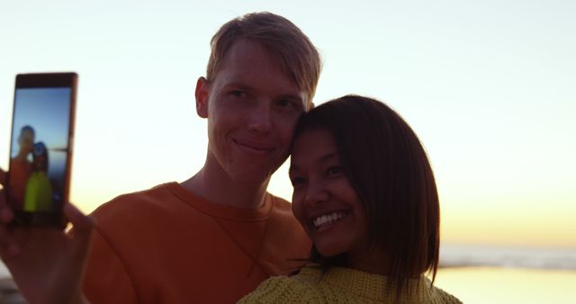 Happy Mixed Couple Taking Selfie at Sunset on Beach - Download Free Stock Images Pikwizard.com