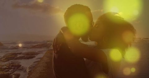 Romantic Couple Embracing by the Ocean at Sunset
