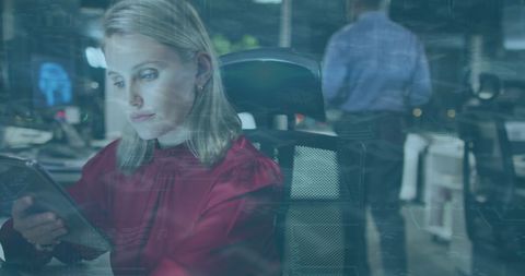 Businesswoman Using Tablet with Digital Data Overlay in Modern Office