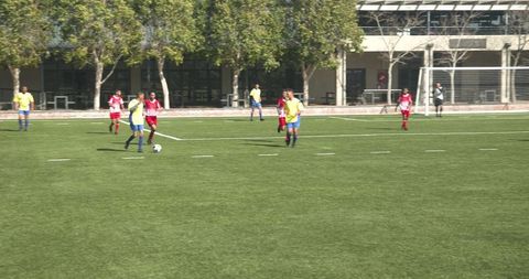 Youth Soccer Match on Sunny School Field