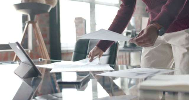 Young Professional Organizing Documents in Modern Office With Large Windows - Download Free Stock Images Pikwizard.com