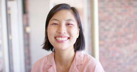 Casual Asian Businesswoman Smiling at Workplace