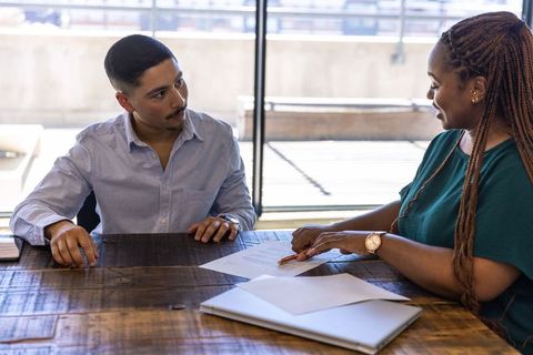 Diverse team collaborating on business document at office table