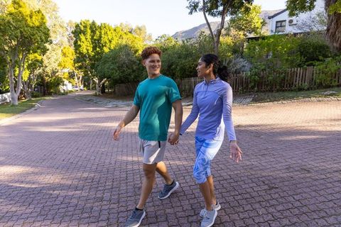 Active couple enjoying nature walk on sunny day