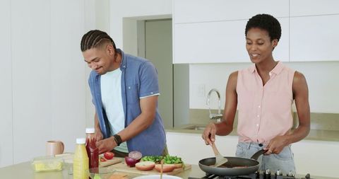 Diverse Couple Preparing Healthy Meal Together in Bright Kitchen